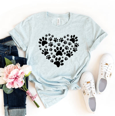 Light blue t-shirt with black paw print heart design, jeans, sneakers, and a flower on a white background