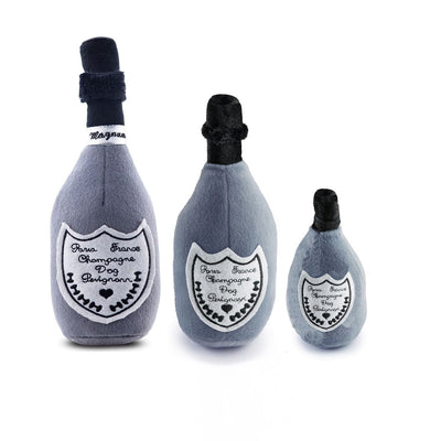Three plush champagne bottle toys on a white background