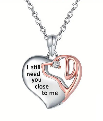 Heart-shaped pendant necklace with engraved message on a white background