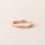 Rose gold ring with 'Forever in My Heart' engraving on a light beige background